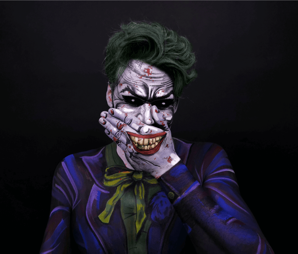 A man with a joker face painted on his face.