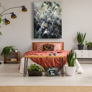 A bedroom with plants and a large painting on the wall, featuring Green Vertigo - SOLD.