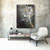 An abstract painting hangs above a chair in a living room, creating an intriguing "The In Between" ambiance.