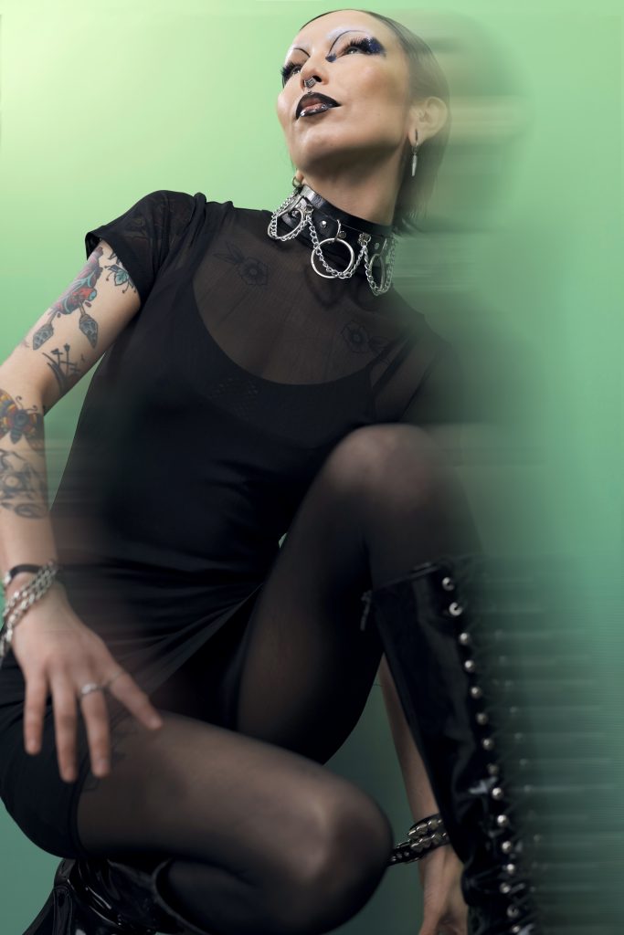 A woman with tattoos posing for a photo.