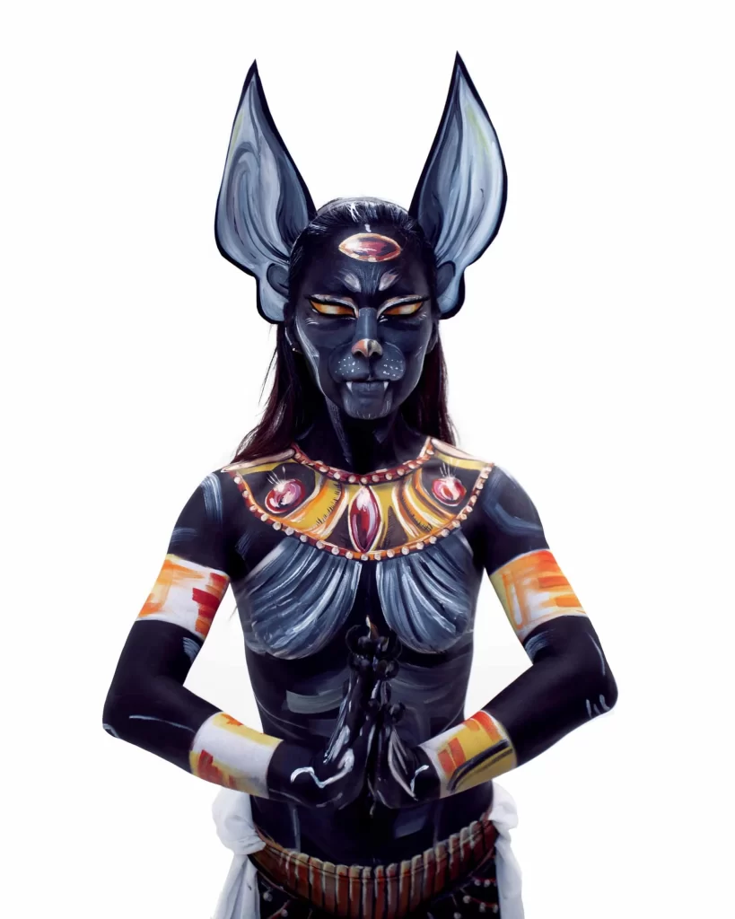 An egyptian woman dressed in black body paint.
